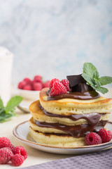 Tasty breakfast. Homemade pancakes with crushed berry, honey or maple syrup on white grey  background.