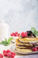 Tasty breakfast. Homemade pancakes with crushed berry, honey or maple syrup on white grey  background.