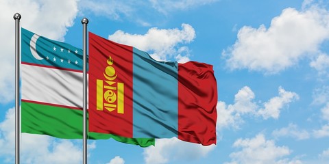 Uzbekistan and Mongolia flag waving in the wind against white cloudy blue sky together. Diplomacy concept, international relations.