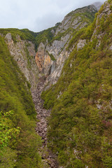 Beautiful landscape view of Boka Waterfall. It is the mightiest waterfall in Slovenia. It high is 106 altitude meters. It has the most width and flow speed in Slovenia.Concept of landscape and nature.