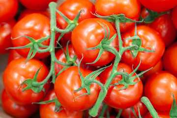 Closeup delicious red cherry tomatoes. Summer tray market agriculture farm full of organic vegetables. Healthy eating. It can be used as a background. (selective focus)
