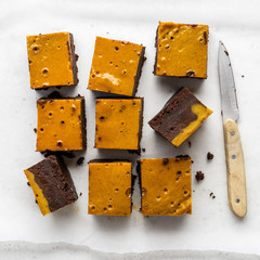 Pumpkin chocolate brownie. Thanksgiving day food. White stone background.