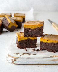 Pumpkin chocolate brownie. Thanksgiving day food. White stone background.
