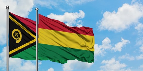 Vanuatu and Bolivia flag waving in the wind against white cloudy blue sky together. Diplomacy concept, international relations.