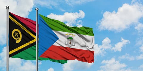 Vanuatu and Equatorial Guinea flag waving in the wind against white cloudy blue sky together....