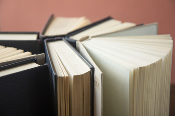 Many Books Piles. Hardback books on wooden table. Books stack texture and background. Back to...