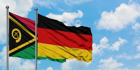 Vanuatu and Germany flag waving in the wind against white cloudy blue sky together. Diplomacy concept, international relations.