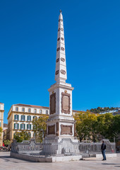 Obraz premium Tourist visiting the memorial obelisk dedicated to General Torrijos in Plaza de la Merced, popular square in the historic centre.