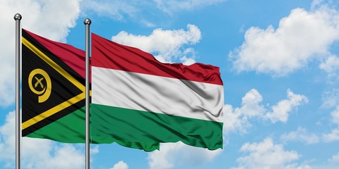 Vanuatu and Hungary flag waving in the wind against white cloudy blue sky together. Diplomacy concept, international relations.