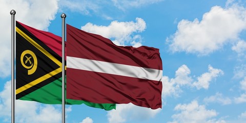 Vanuatu and Latvia flag waving in the wind against white cloudy blue sky together. Diplomacy concept, international relations.