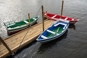 Fototapeta na wymiar three rowing boats on a jetty