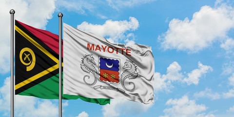 Vanuatu and Mayotte flag waving in the wind against white cloudy blue sky together. Diplomacy...