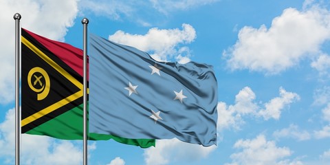Vanuatu and Micronesia flag waving in the wind against white cloudy blue sky together. Diplomacy...