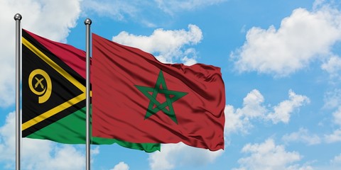 Vanuatu and Morocco flag waving in the wind against white cloudy blue sky together. Diplomacy concept, international relations.