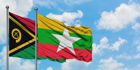 Vanuatu and Myanmar flag waving in the wind against white cloudy blue sky together. Diplomacy concept, international relations.