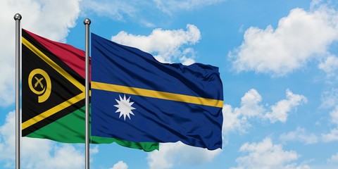 Vanuatu and Nauru flag waving in the wind against white cloudy blue sky together. Diplomacy...