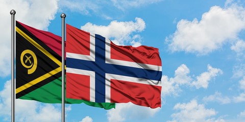 Vanuatu and Norway flag waving in the wind against white cloudy blue sky together. Diplomacy...