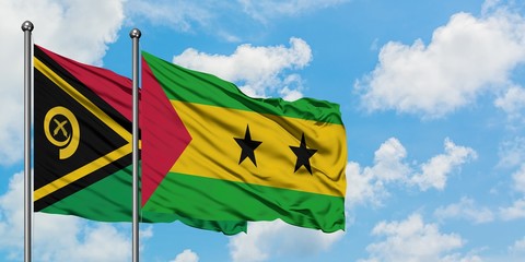 Vanuatu and Sao Tome And Principe flag waving in the wind against white cloudy blue sky together. Diplomacy concept, international relations.