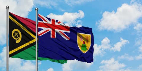 Vanuatu and Turks And Caicos Islands flag waving in the wind against white cloudy blue sky together. Diplomacy concept, international relations.