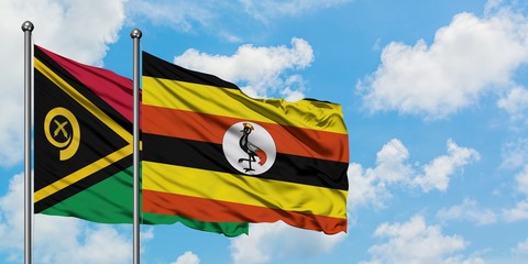 Vanuatu and Uganda flag waving in the wind against white cloudy blue sky together. Diplomacy concept, international relations.
