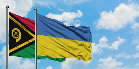 Vanuatu and Ukraine flag waving in the wind against white cloudy blue sky together. Diplomacy concept, international relations.