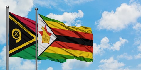 Vanuatu and Zimbabwe flag waving in the wind against white cloudy blue sky together. Diplomacy concept, international relations.