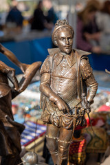 Trinket and close-up bronze figurine on antique flea market in Barcelona Spain