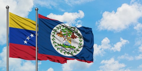 Venezuela and Belize flag waving in the wind against white cloudy blue sky together. Diplomacy concept, international relations.