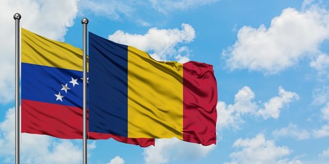 Venezuela and Chad flag waving in the wind against white cloudy blue sky together. Diplomacy concept, international relations.