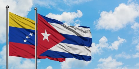 Venezuela and Cuba flag waving in the wind against white cloudy blue sky together. Diplomacy concept, international relations.