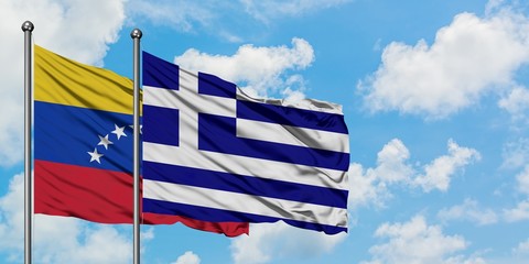 Venezuela and Greece flag waving in the wind against white cloudy blue sky together. Diplomacy concept, international relations.
