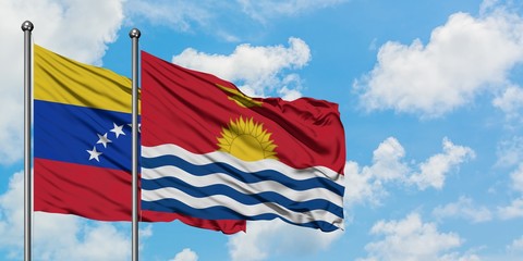 Venezuela and Kiribati flag waving in the wind against white cloudy blue sky together. Diplomacy concept, international relations.