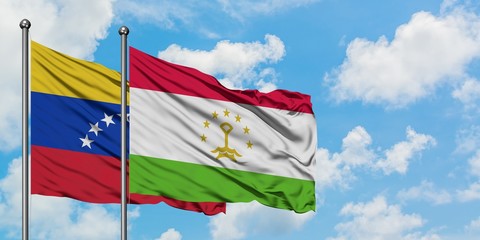 Venezuela and Tajikistan flag waving in the wind against white cloudy blue sky together. Diplomacy concept, international relations.
