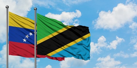 Venezuela and Tanzania flag waving in the wind against white cloudy blue sky together. Diplomacy concept, international relations.