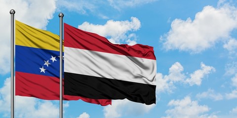 Venezuela and Yemen flag waving in the wind against white cloudy blue sky together. Diplomacy concept, international relations.