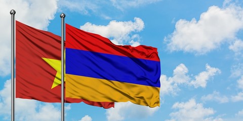 Vietnam and Armenia flag waving in the wind against white cloudy blue sky together. Diplomacy concept, international relations.
