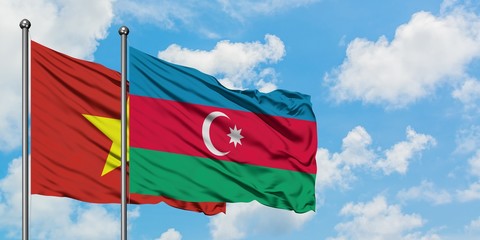 Vietnam and Azerbaijan flag waving in the wind against white cloudy blue sky together. Diplomacy concept, international relations.