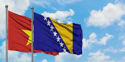 Vietnam and Bosnia Herzegovina flag waving in the wind against white cloudy blue sky together. Diplomacy concept, international relations.