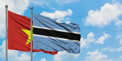 Vietnam and Botswana flag waving in the wind against white cloudy blue sky together. Diplomacy concept, international relations.