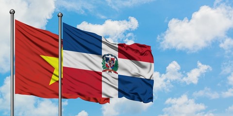 Vietnam and Dominican Republic flag waving in the wind against white cloudy blue sky together. Diplomacy concept, international relations.