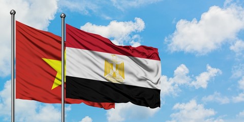 Vietnam and Egypt flag waving in the wind against white cloudy blue sky together. Diplomacy concept, international relations.