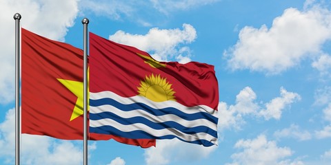 Vietnam and Kiribati flag waving in the wind against white cloudy blue sky together. Diplomacy concept, international relations.