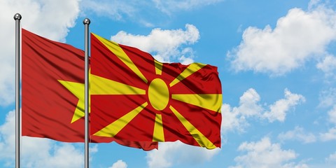 Vietnam and Macedonia flag waving in the wind against white cloudy blue sky together. Diplomacy concept, international relations.