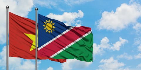 Vietnam and Namibia flag waving in the wind against white cloudy blue sky together. Diplomacy concept, international relations.