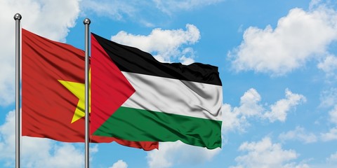 Vietnam and Palestine flag waving in the wind against white cloudy blue sky together. Diplomacy concept, international relations.