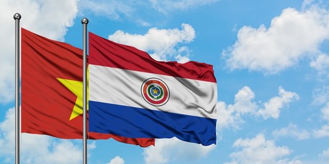 Vietnam and Paraguay flag waving in the wind against white cloudy blue sky together. Diplomacy concept, international relations.