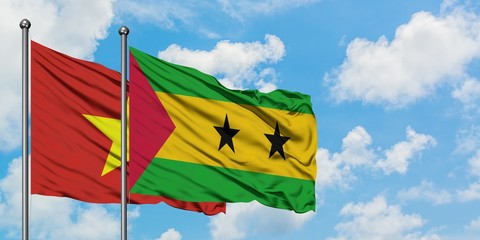 Vietnam and Sao Tome And Principe flag waving in the wind against white cloudy blue sky together. Diplomacy concept, international relations.