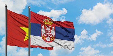 Vietnam and Serbia flag waving in the wind against white cloudy blue sky together. Diplomacy concept, international relations.