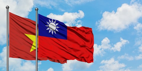 Vietnam and Taiwan flag waving in the wind against white cloudy blue sky together. Diplomacy concept, international relations.