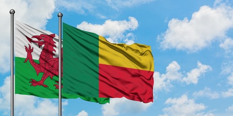 Wales and Benin flag waving in the wind against white cloudy blue sky together. Diplomacy concept, international relations.